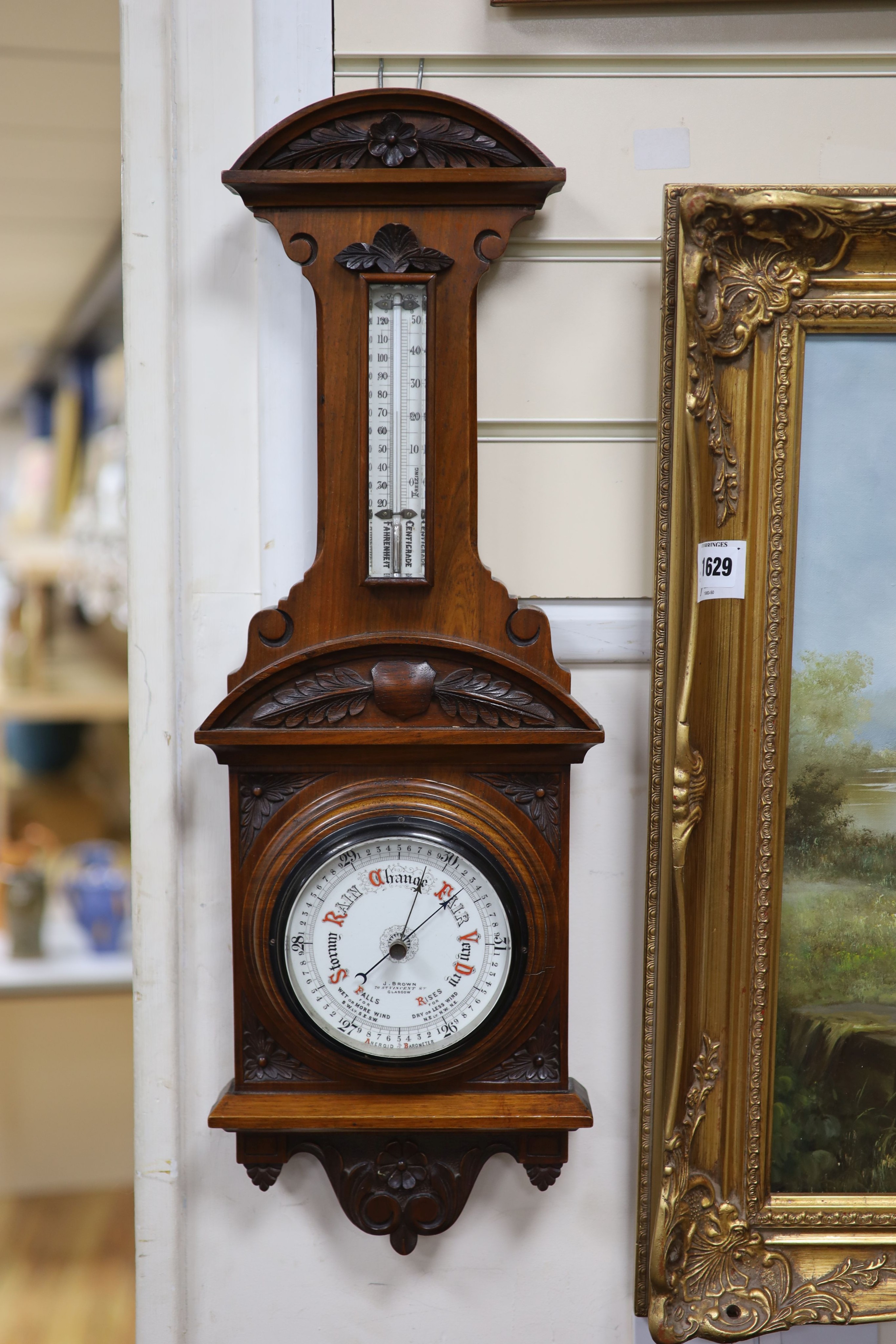 J Brown, Glasgow, a late Victorian carved walnut cased aneroid barometer and thermometer, height 65cm